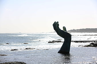 Bronze Hand Sculpture Emerging from Ocean Waves in Pohang