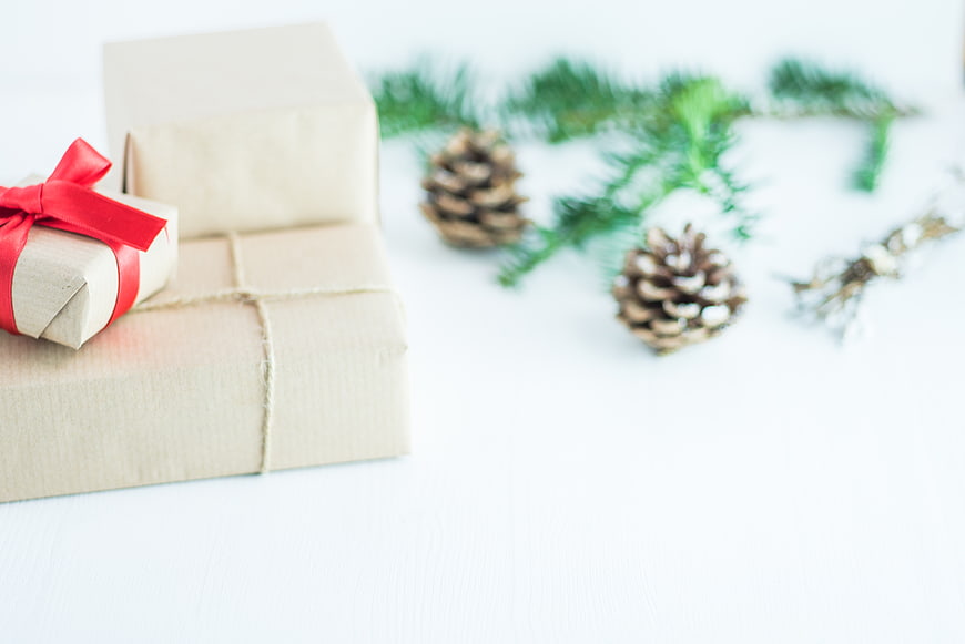 Rustic Christmas gifts with pine cones and fir branches