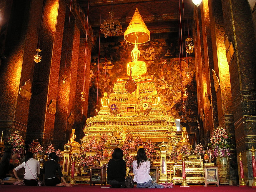 Golden Buddha Statue in Thai Temple with Worshippers