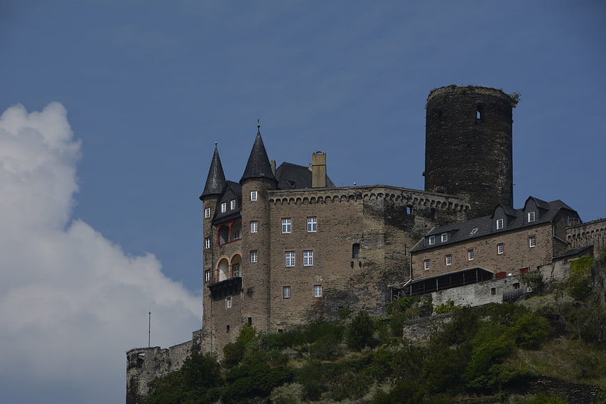 Medieval Castle on Hillside with Blue Sky and Clouds
