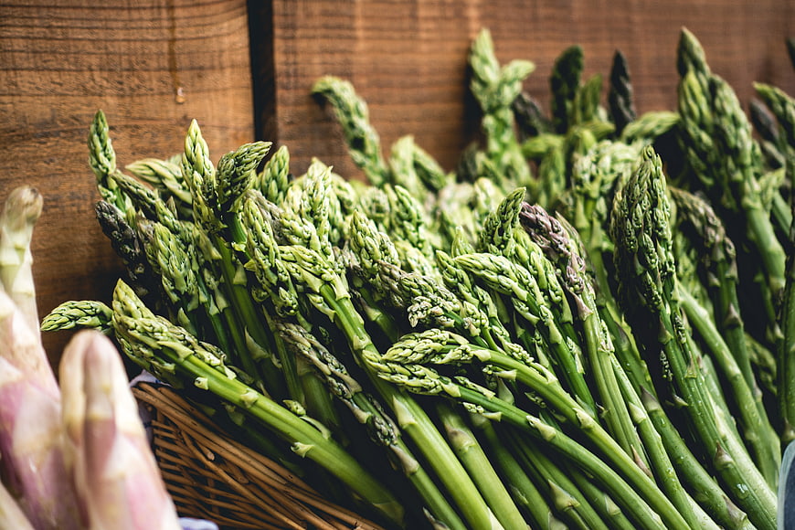 Fresh Green Asparagus Bunch on Wooden Background