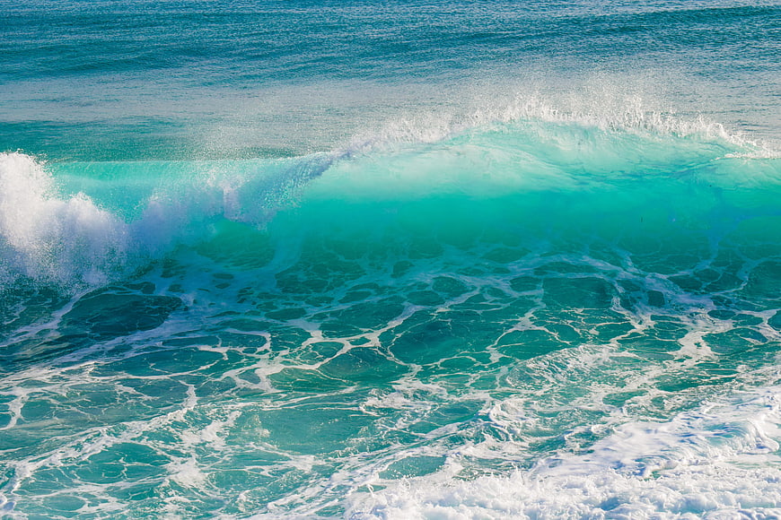 Turquoise Ocean Wave Breaking With White Sea Foam