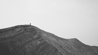 Two Hikers Standing on a Rocky Mountain Peak in Black and White
