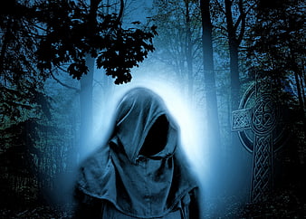 Mysterious hooded figure in dark blue forest with Celtic cross