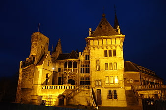 Illuminated historic castle architecture at night in Antwerp