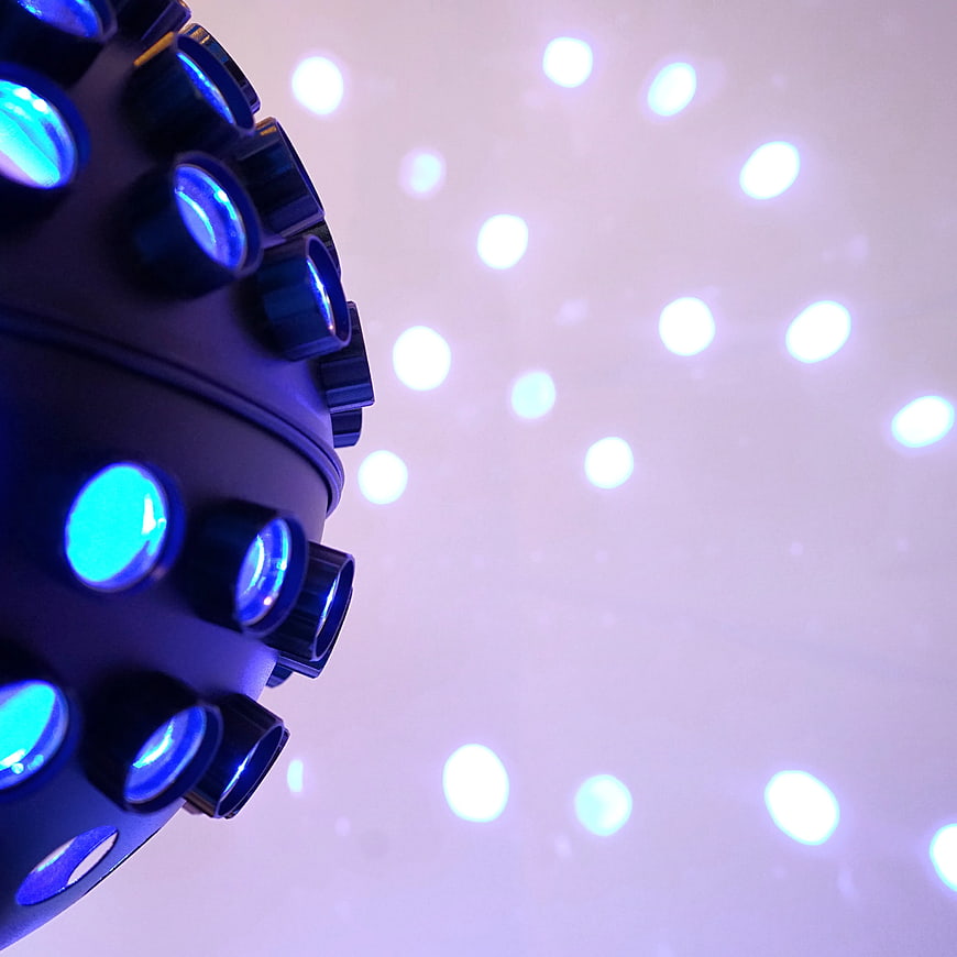 Close-up of black strobe light with blue bokeh background