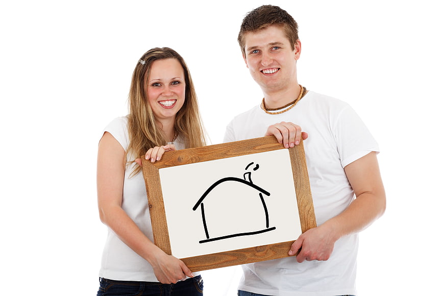 Happy couple holding house sign for real estate concept