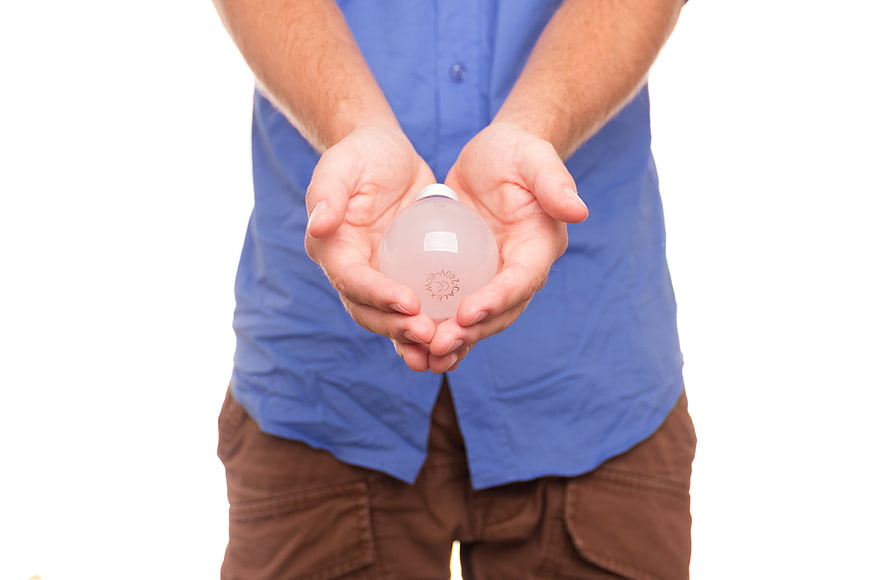 Man holding light bulb in hands on white background