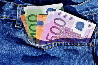Euro banknotes tucked into a blue denim jeans pocket
