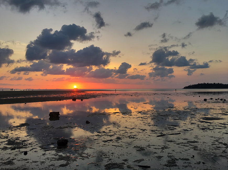 Sunset Reflection on Wet Beach with Clouds