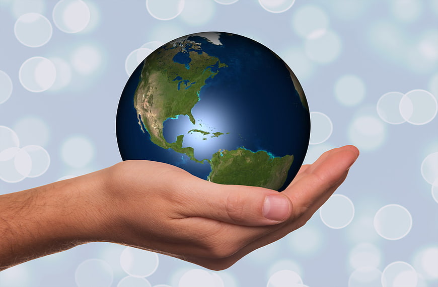 Hand holding globe of Earth with Americas visible