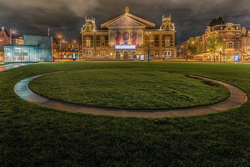 Night view of Concertgebouw Amsterdam with circular grass foreground
