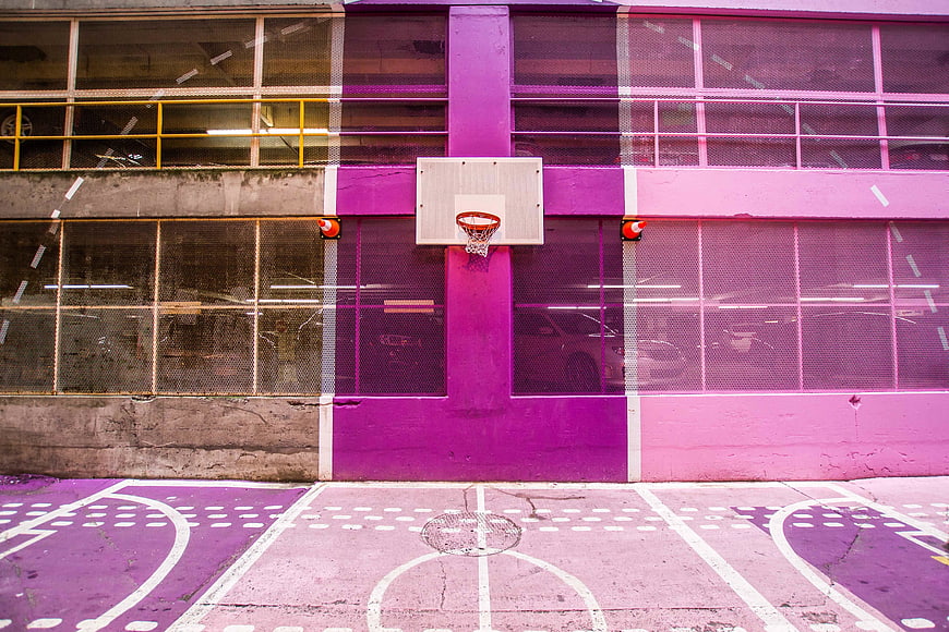 Vibrant purple and pink urban basketball court with hoop
