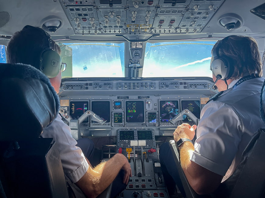 Two pilots flying a commercial airplane cockpit view