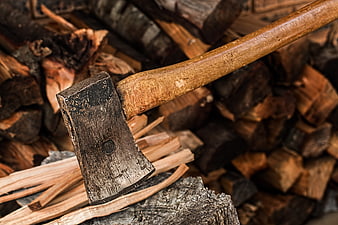Rusty Hatchet Resting on Split Firewood and Kindling
