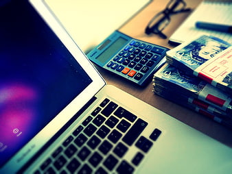 Laptop, Calculator, and Cash on Desk for Finance Concept