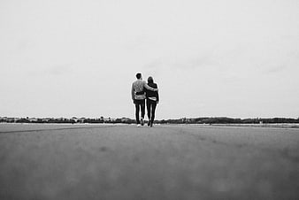 Couple Walking Away on Open Road in Black and White