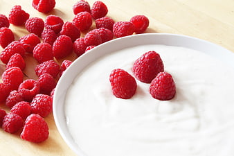 Fresh Raspberries and White Yogurt on Wooden Table