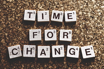 Scrabble tiles spelling Time For Change on cork background