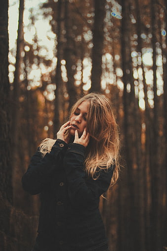 Pensive Woman in Denim Jacket in Autumn Forest