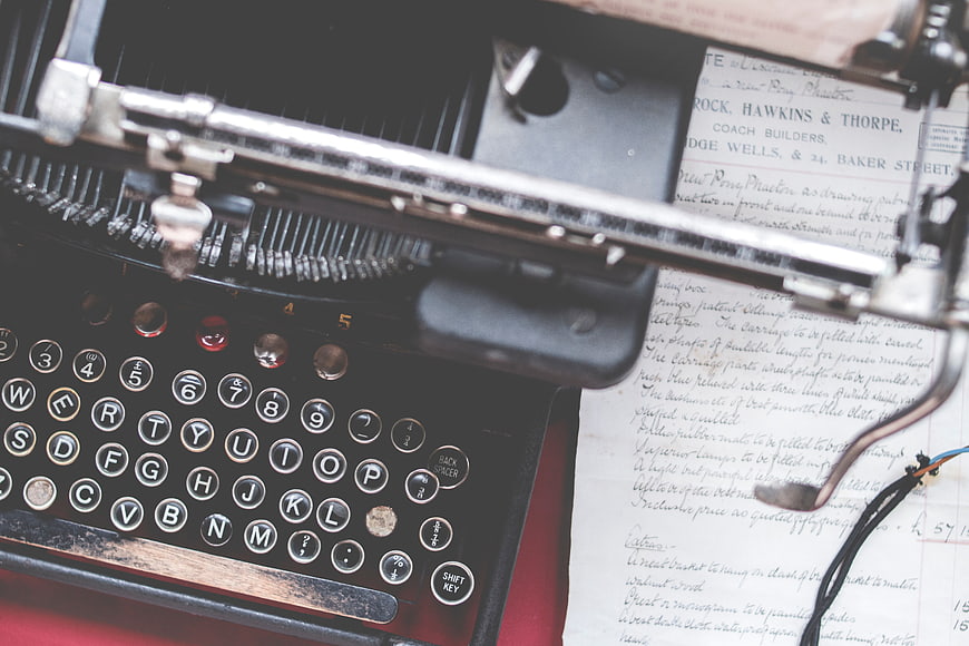 Vintage Typewriter Close-Up with Handwritten Document