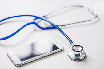 Blue Stethoscope and Smartphone on White Background