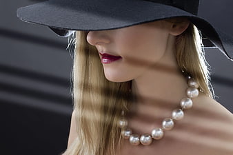 Elegant Woman in Black Hat with Pearl Necklace
