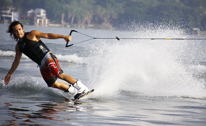 Man Wakeboarding with Splash on Sunny Day