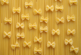 Top View of Farfalle Pasta on Spaghetti Background