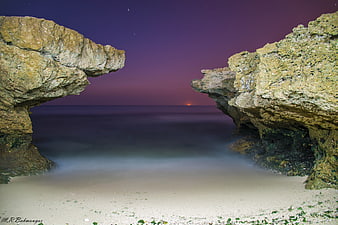 Dramatic Coastal Rock Formations at Twilight with Smooth Ocean