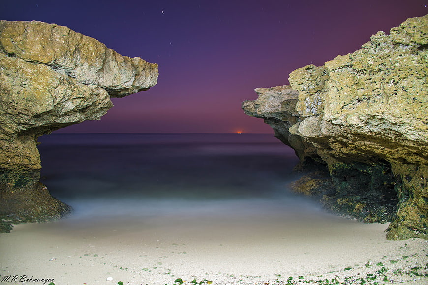 Dramatic Coastal Rock Formations at Twilight with Smooth Ocean
