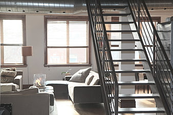 Modern Loft Interior with Metal Staircase and Exposed Ducts