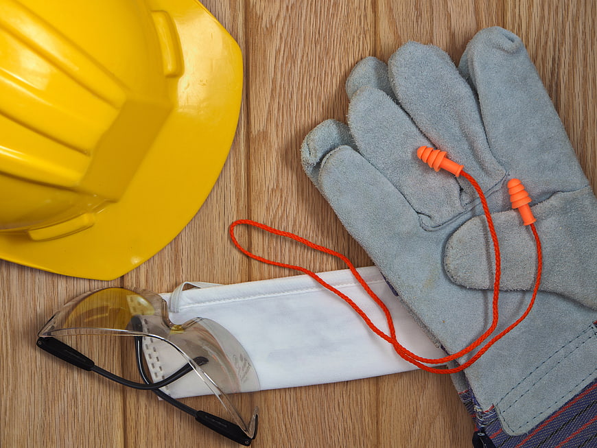 Construction Safety Equipment Flat Lay on Wooden Background