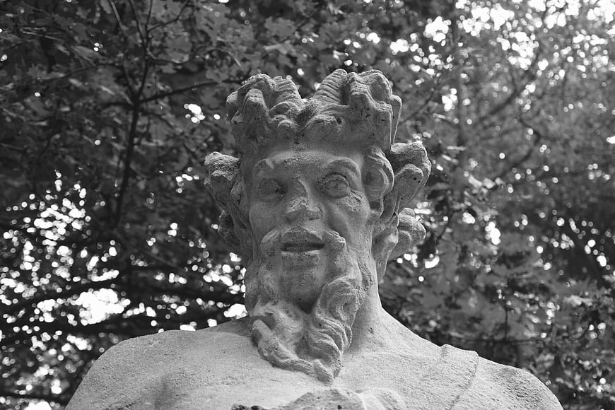 Black and white close-up of weathered stone statue head