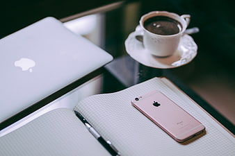 Rose Gold iPhone, Notebook, and Coffee on Desk