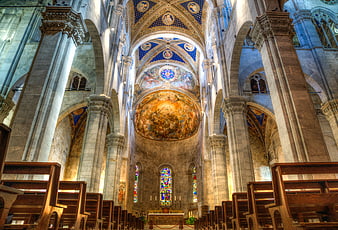 Interior of Lucca Cathedral with painted dome and stained glass