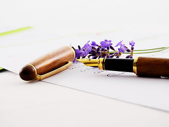 Wooden Fountain Pen and Lavender Sprig on White Paper