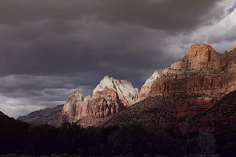 Dramatic Red Rock Mountains Under Stormy Clouds