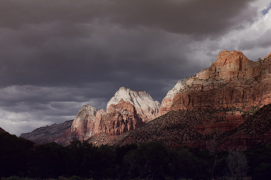 Dramatic Red Rock Mountains Under Stormy Clouds