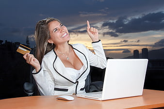 Smiling Business Woman with Credit Card and Laptop