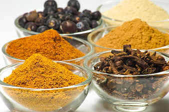 Assorted Spices in Glass Bowls on White Background
