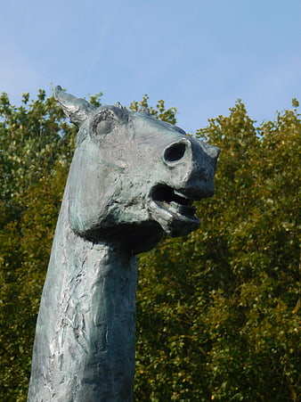 Bronze Horse Head Sculpture Against Blue Sky