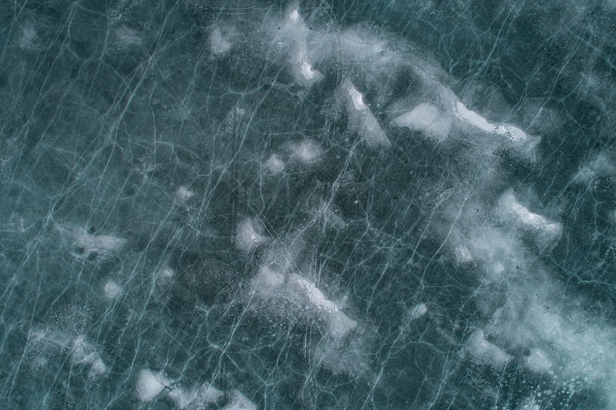 Abstract Frozen Ice Texture with Cracks and Snow