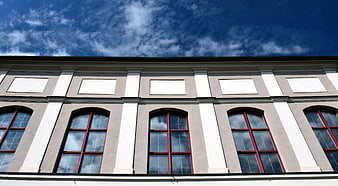 Classical building facade with arched windows and blue sky