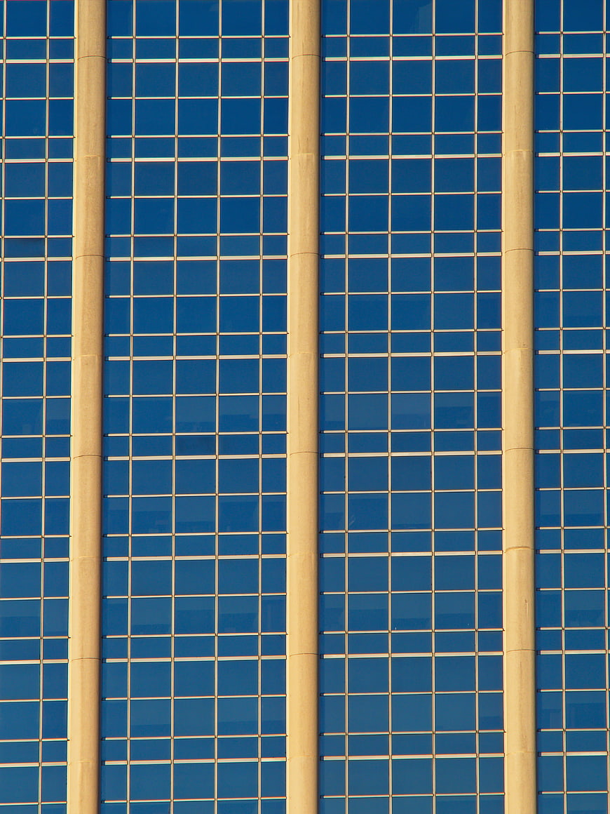 Abstract Blue Glass Building Facade with Vertical Columns