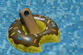 Wooden vape device in donut pool float