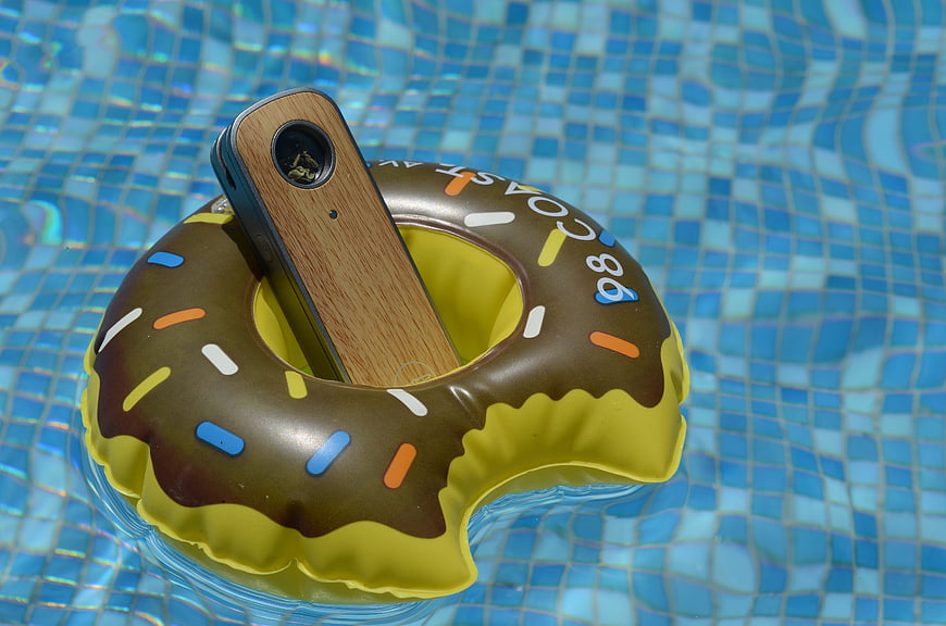 Wooden vape device in donut pool float