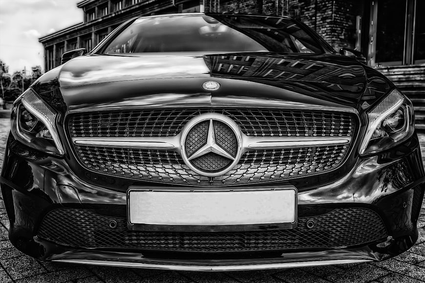 Front view of black Mercedes-Benz luxury car in black and white