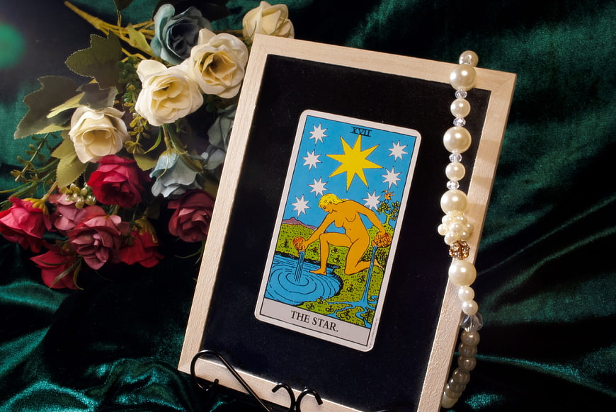The Star Tarot Card Displayed in Frame with Flowers and Pearls