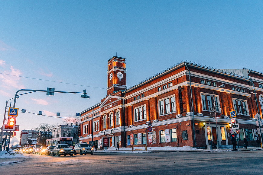 Red brick theater building with clock tower in winter city